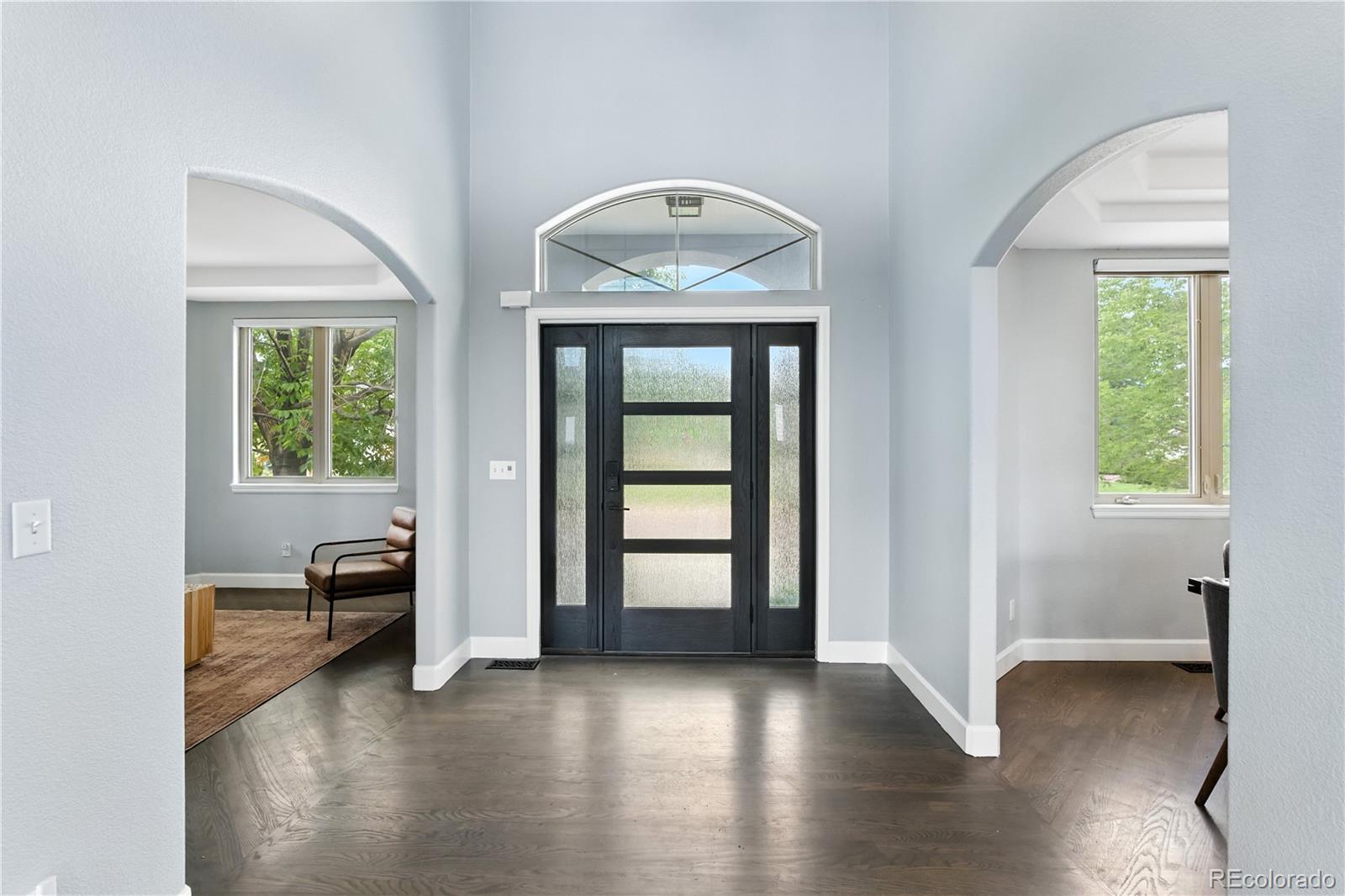7092 Secrest Court Arvada, CO 80007 - Photo 4 of 49 an empty room with wooden floor and windows