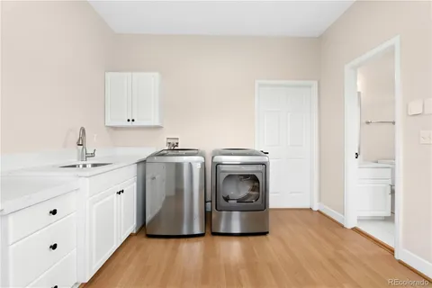 a utility room with sink dryer and washer