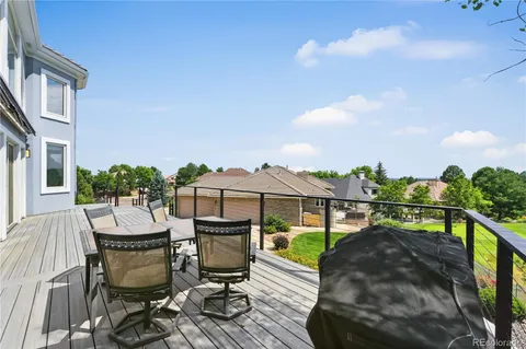 a balcony with table and chairs