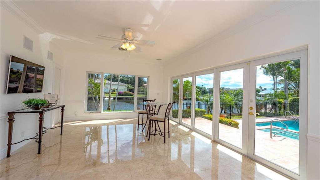 2 Compass Lane Fort Lauderdale, FL 33308 - Photo 12 of 43 a view of a dining room with furniture large windows and wooden floor