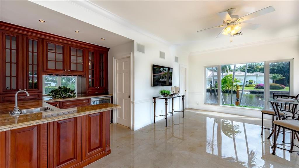 2 Compass Lane Fort Lauderdale, FL 33308 - Photo 13 of 43 a living room with furniture a flat screen tv and a floor to ceiling window