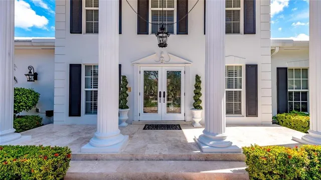 a bedroom with furniture and a large window