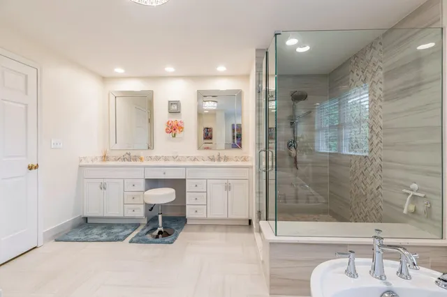 a bathroom with a sink double vanity and shower