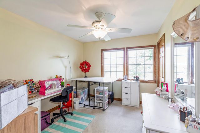 a bedroom with furniture a bed and a chandelier