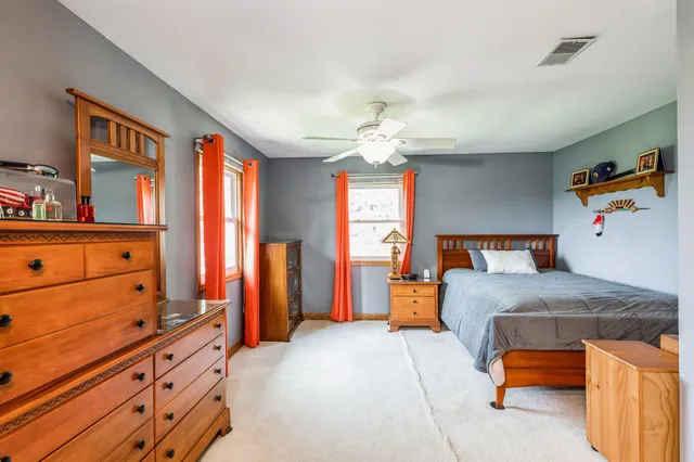 a bedroom with a bed and dresser