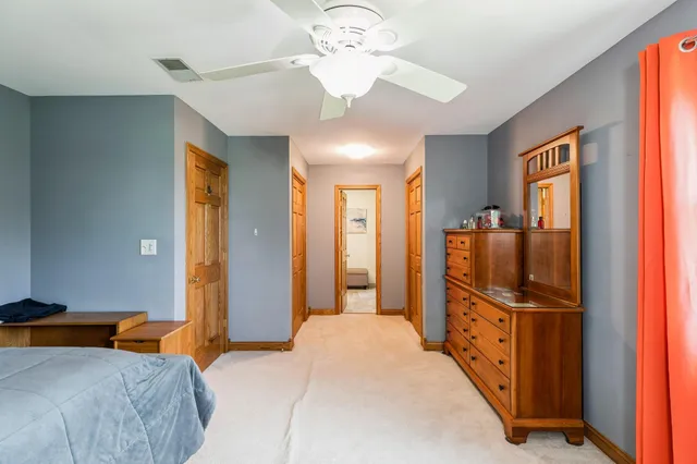 a bedroom with chandelier and mirror