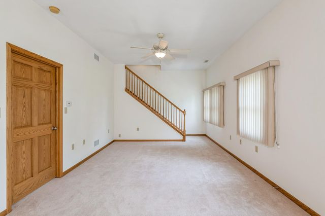 a kitchen with a refrigerator a sink and cabinets