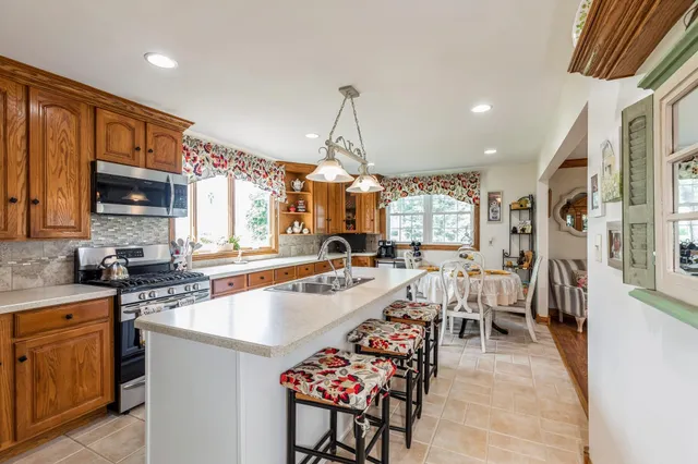 a large kitchen with lots of counter space a sink a window and appliances