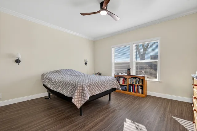 a bedroom with a bed next to a large window