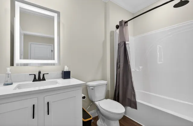 a bathroom with a sink toilet and shower