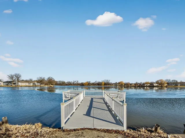 a view of a terrace with lawn chairs