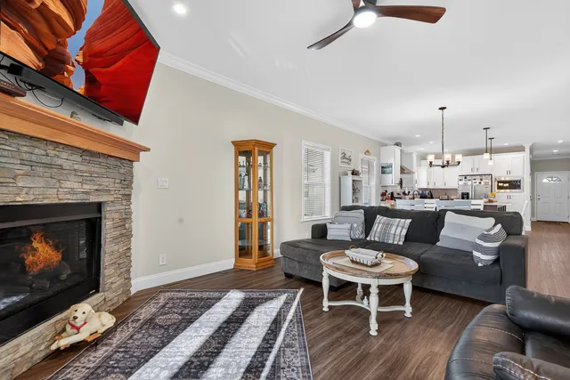 a living room with furniture a rug and a fireplace