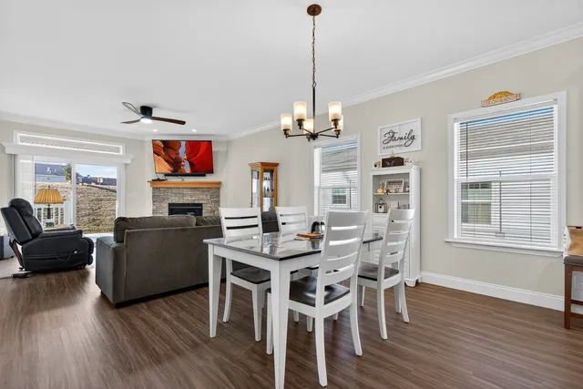 a living room with fireplace furniture and a wooden floor