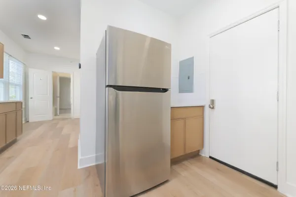 a kitchen with stainless steel appliances granite countertop a stove top oven a sink and a refrigerator