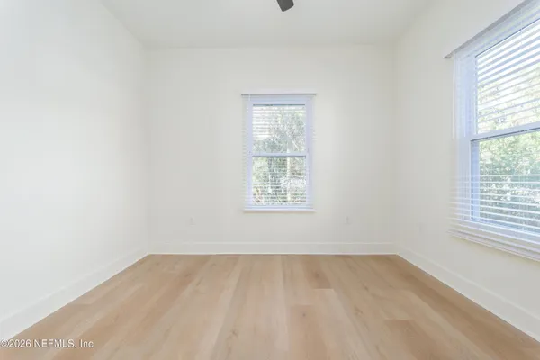 a view of kitchen with stainless steel appliances cabinets and a window