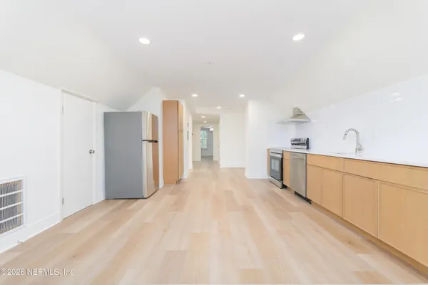 a kitchen with cabinets and white appliances