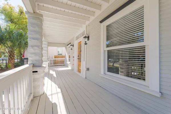 a view of a house with a wooden deck