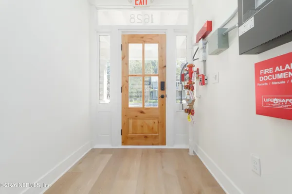 a view of an entryway with wooden floor