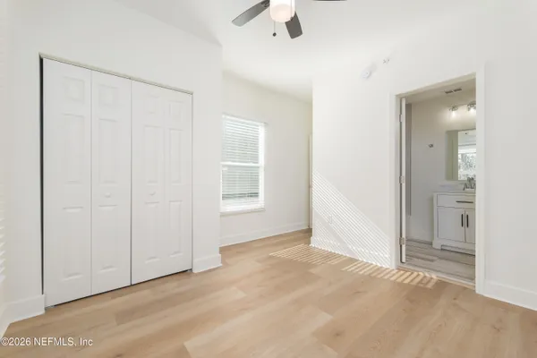 a view of kitchen with stainless steel appliances a refrigerator and wooden floor