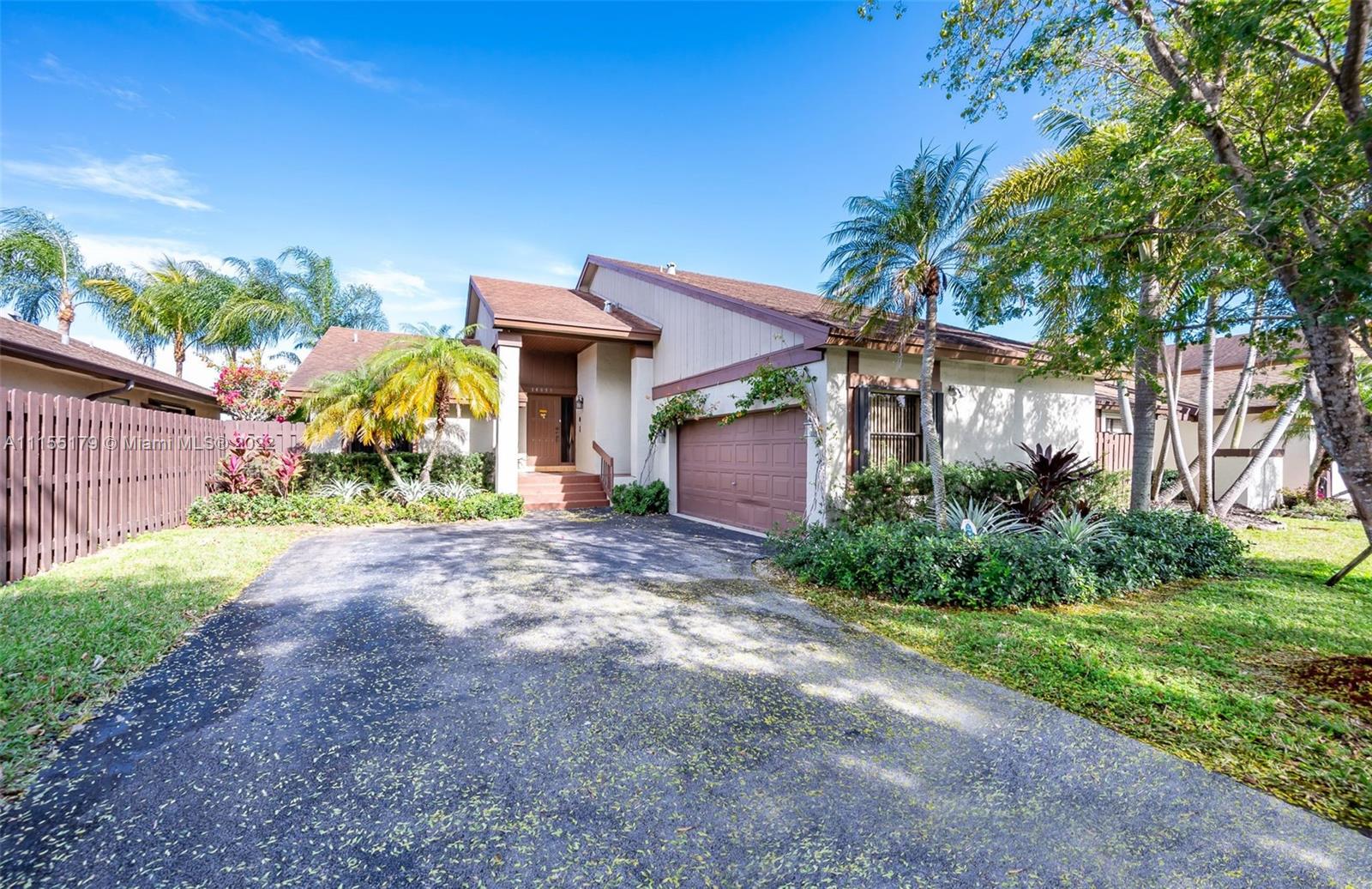 14853 Southwest 42nd Lane Miami, FL 33185 - Photo 1 of 28 a front view of a house with garden