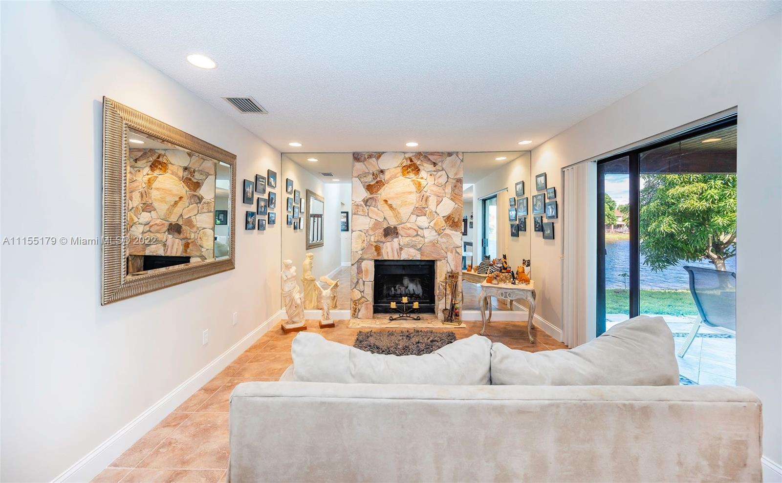 14853 Southwest 42nd Lane Miami, FL 33185 - Photo 14 of 28 a living room with fireplace furniture and a large window