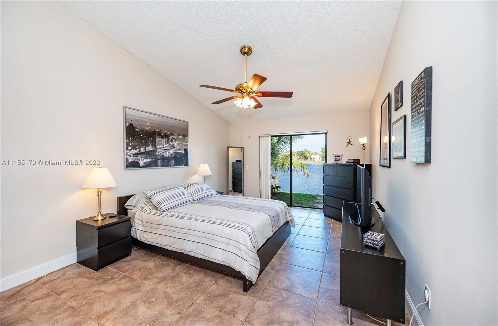 14853 Southwest 42nd Lane Miami, FL 33185 - Photo 16 of 28 a bedroom with a bed furniture and a window
