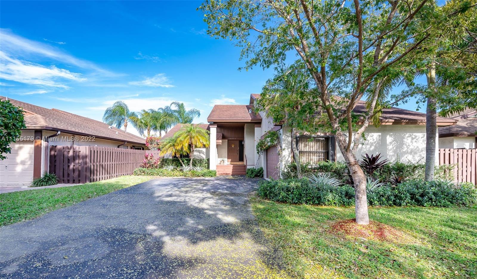 14853 Southwest 42nd Lane Miami, FL 33185 - Photo 2 of 28 a front view of a house with garden