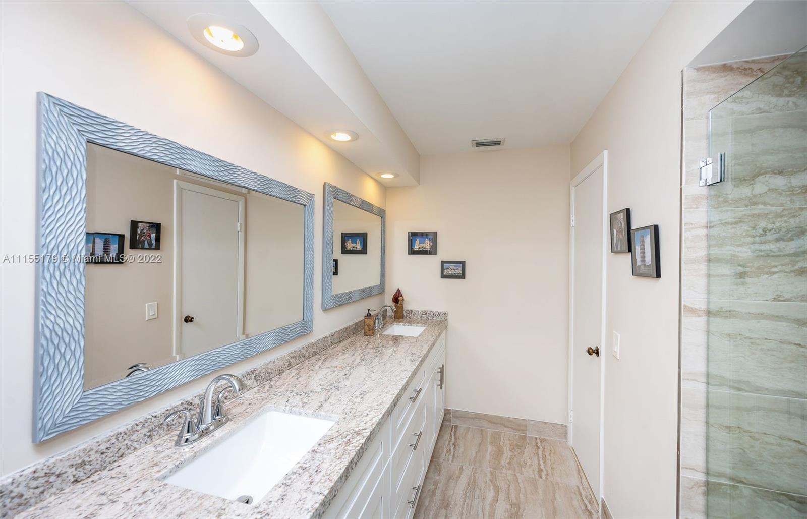 14853 Southwest 42nd Lane Miami, FL 33185 - Photo 23 of 28 a spacious bathroom with a granite countertop sink and a mirror