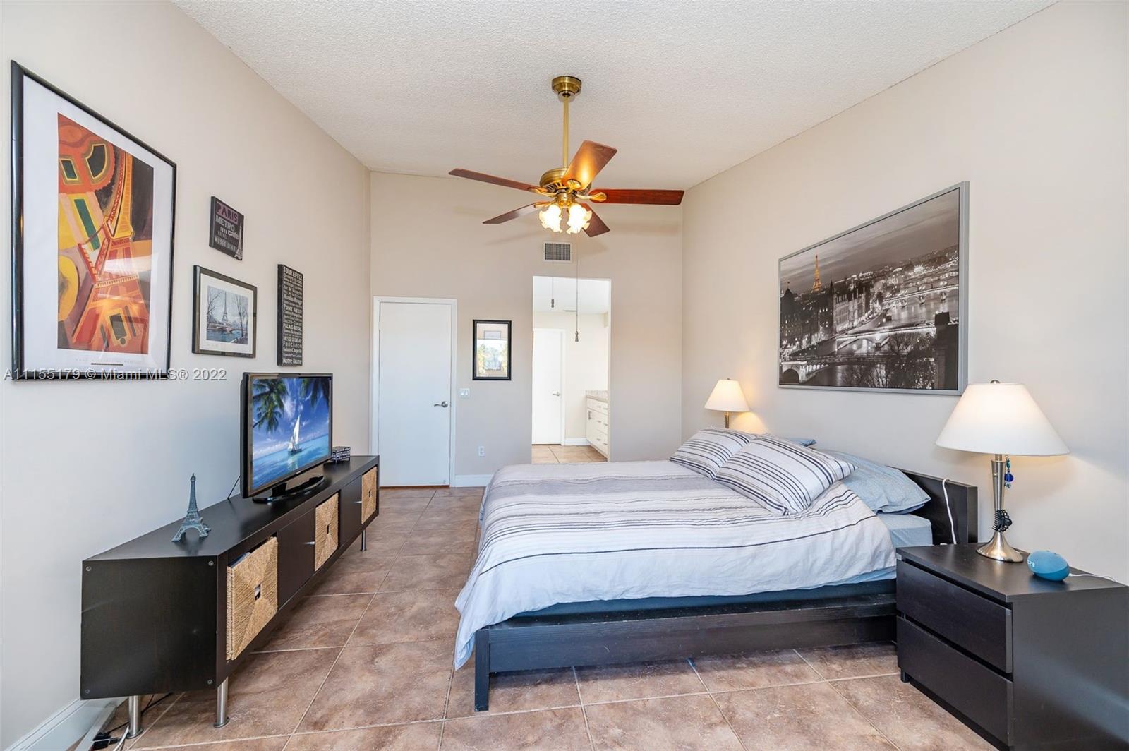 14853 Southwest 42nd Lane Miami, FL 33185 - Photo 26 of 28 a bedroom with bed and a chandelier
