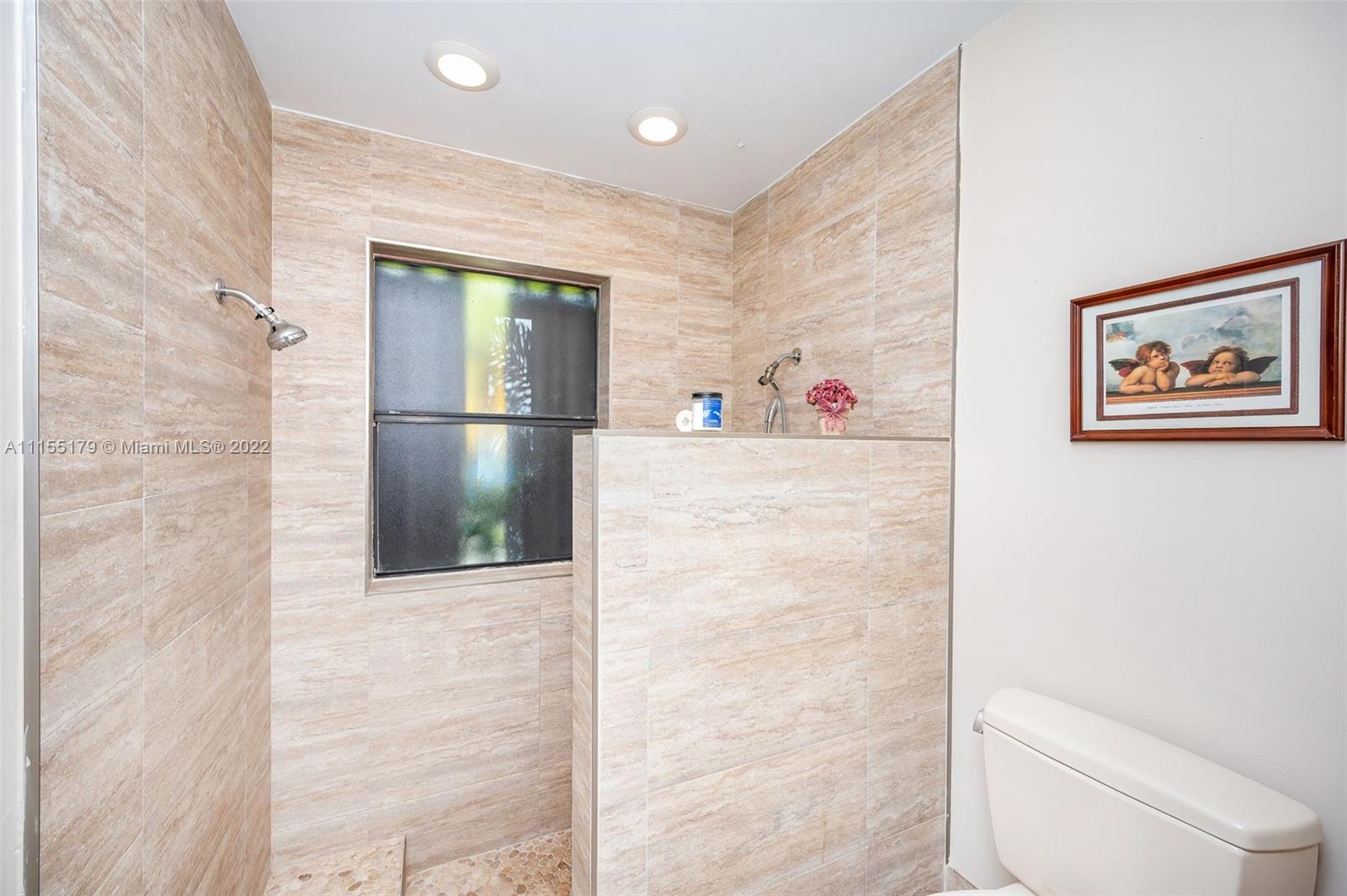 14853 Southwest 42nd Lane Miami, FL 33185 - Photo 27 of 28 a hallway with painting on the wall and a shower
