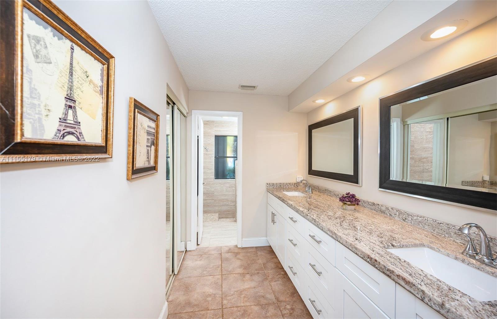14853 Southwest 42nd Lane Miami, FL 33185 - Photo 28 of 28 a spacious bathroom with a granite countertop double vanity sink and a large mirror