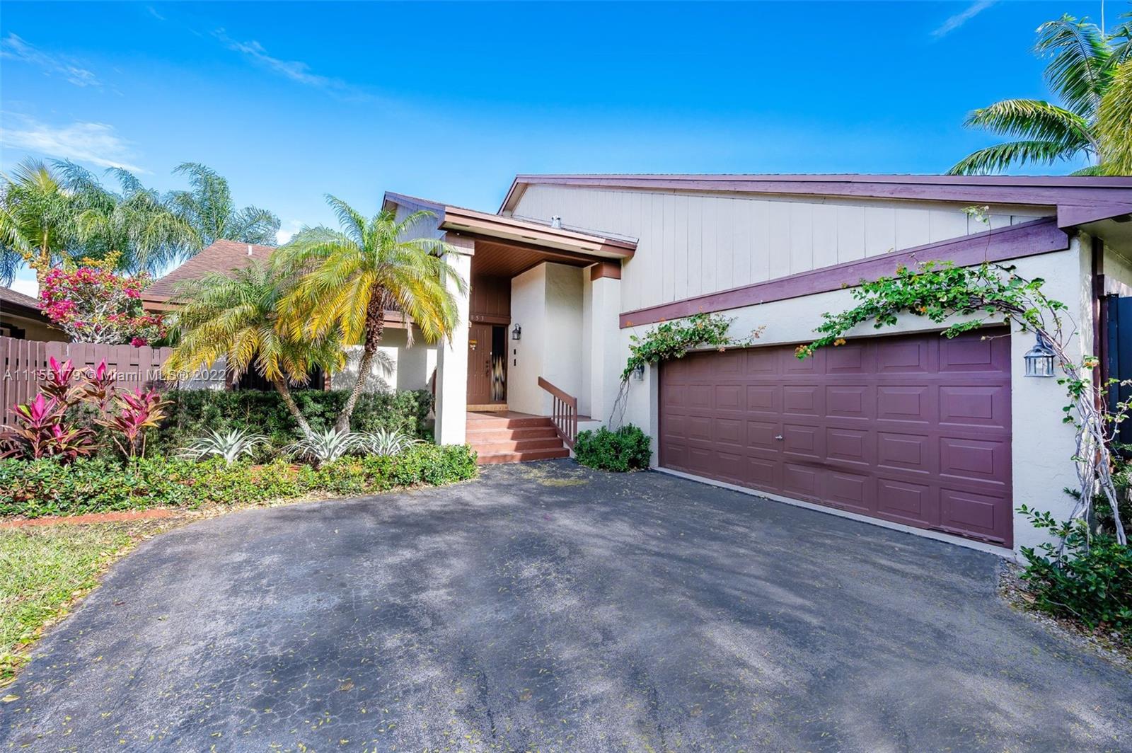 14853 Southwest 42nd Lane Miami, FL 33185 - Photo 3 of 28 a front view of a house with a yard