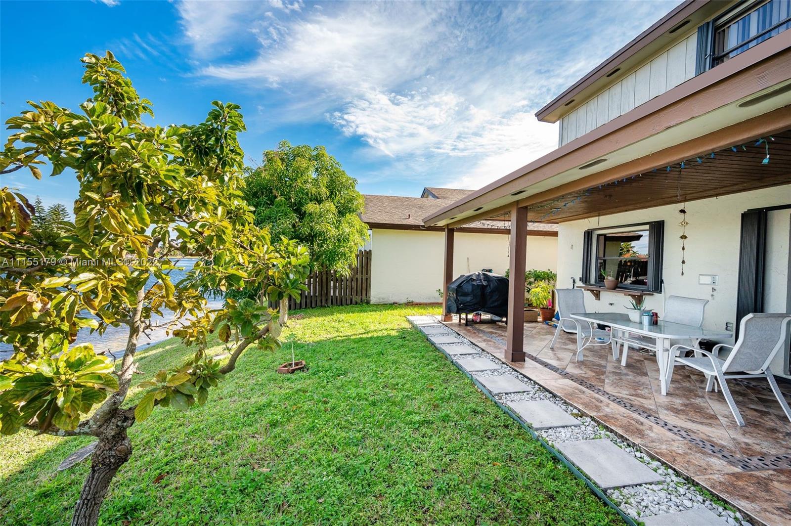 14853 Southwest 42nd Lane Miami, FL 33185 - Photo 8 of 28 a backyard of a house with seating space