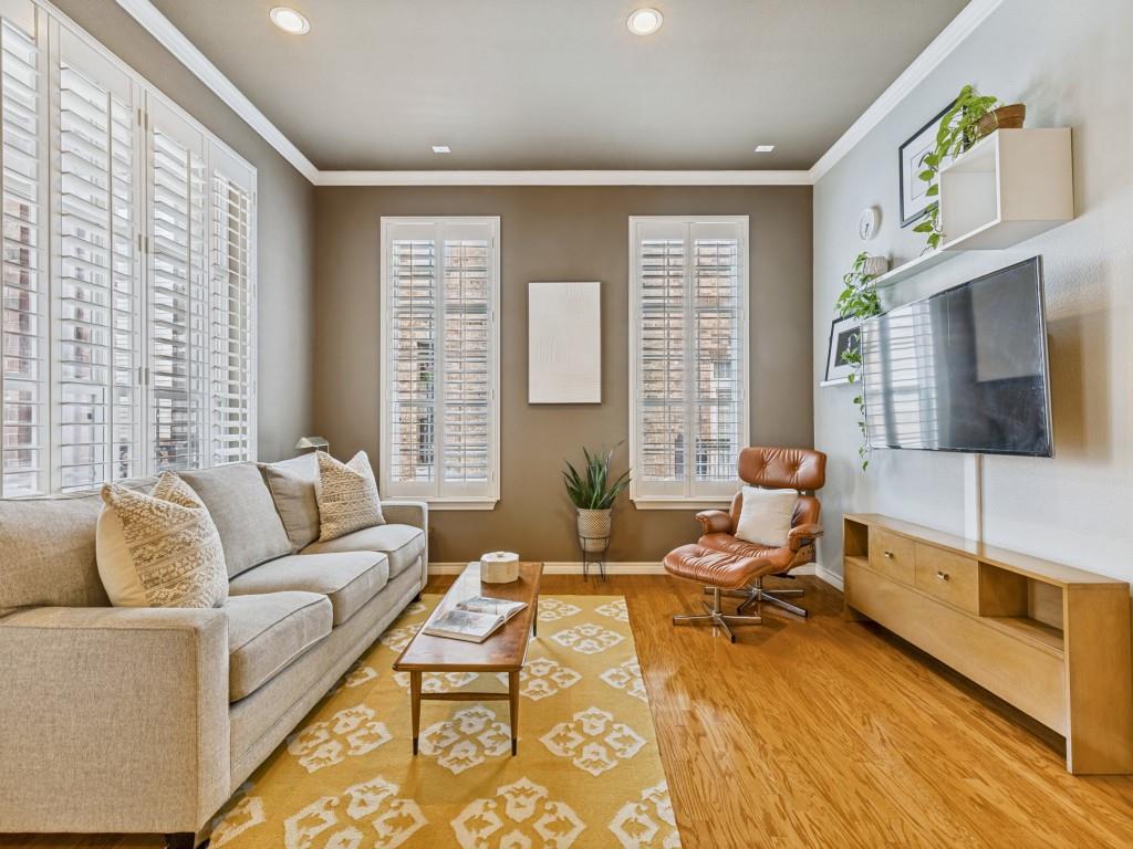 a living room with furniture wooden floor and a flat screen tv