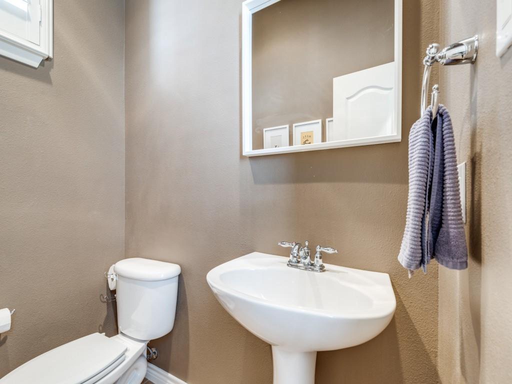 15741 Seabolt Place, Unit 28 Addison, TX 75001 - Photo 23 of 37 a bathroom with a sink a toilet and mirror