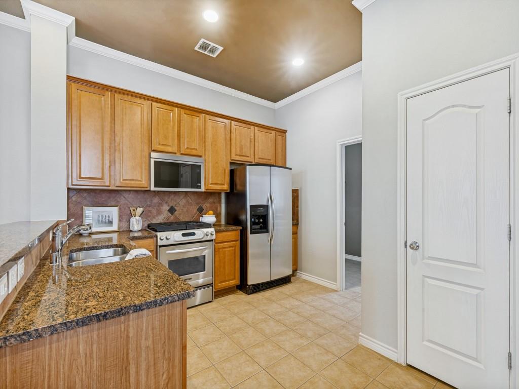 15741 Seabolt Place, Unit 28 Addison, TX 75001 - Photo 9 of 37 a kitchen with a sink stove and refrigerator