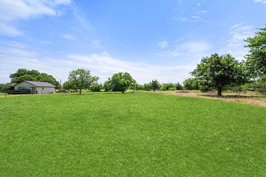 1009 North Spikes Road Corsicana, TX 75110 - Photo 28 of 31 a backyard of a house with lots of green space and garden