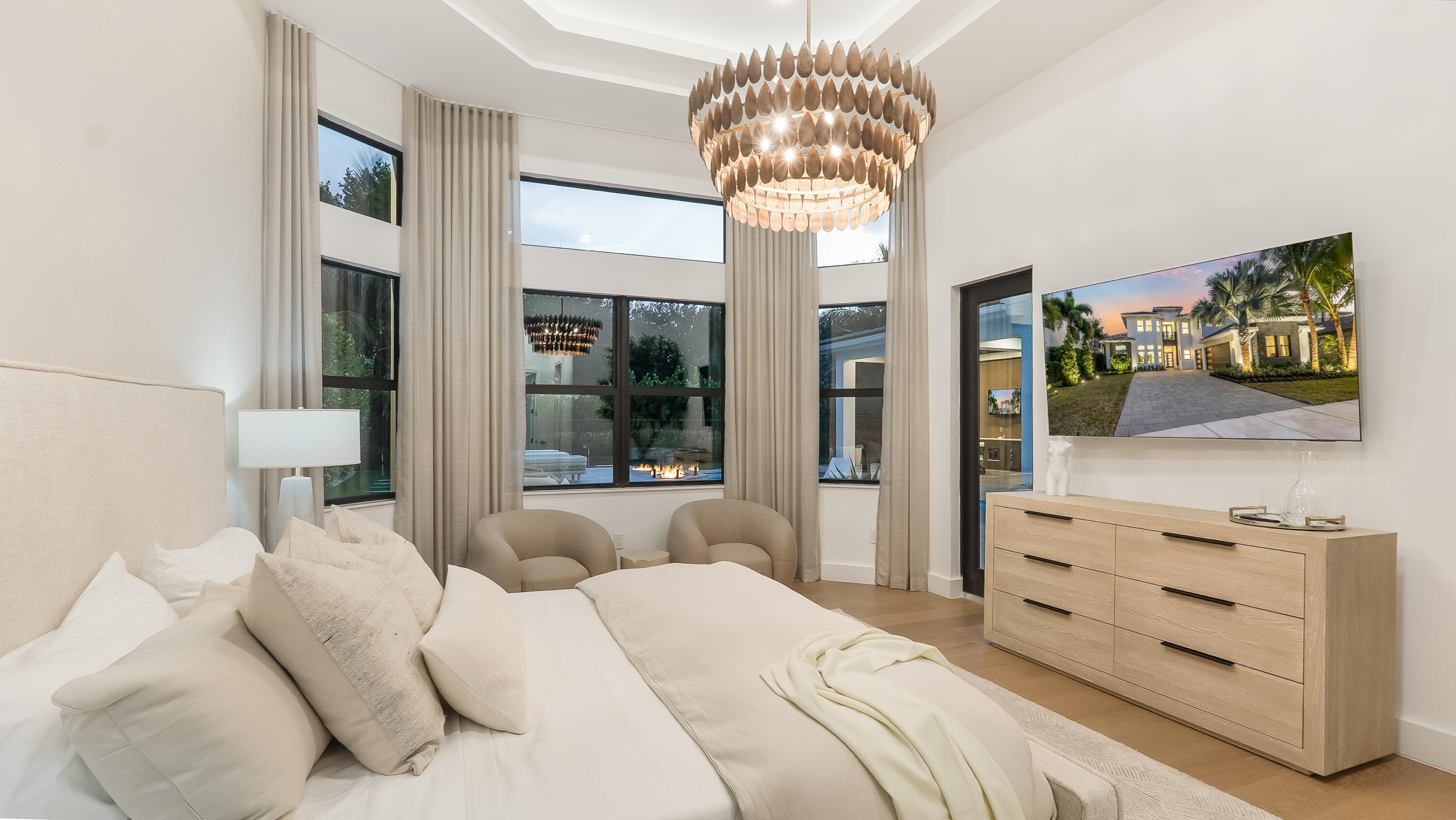 17400 Rosella Road Boca Raton, FL 33496 - Photo 22 of 94 a bedroom with a large bed and a chandelier