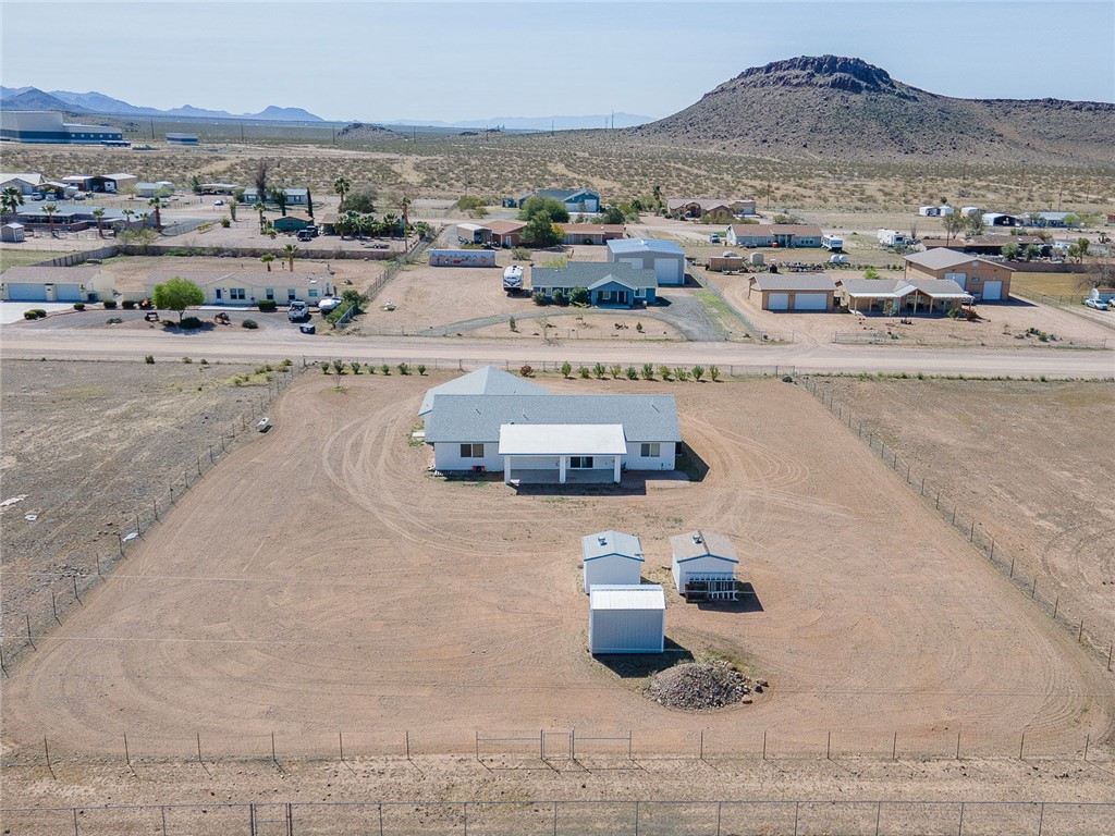 3411 West Carmichael Road Golden Valley, AZ 86413 - Photo 92 of 97 Aerial perspective of suburban area with a mountainous background and a desert landscape