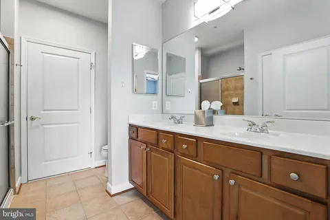a bathroom with a double vanity sink and mirror
