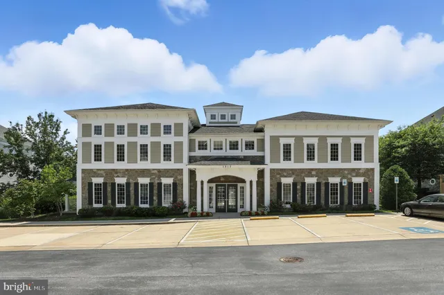 a view of a patio with a table and chairs and potted plants