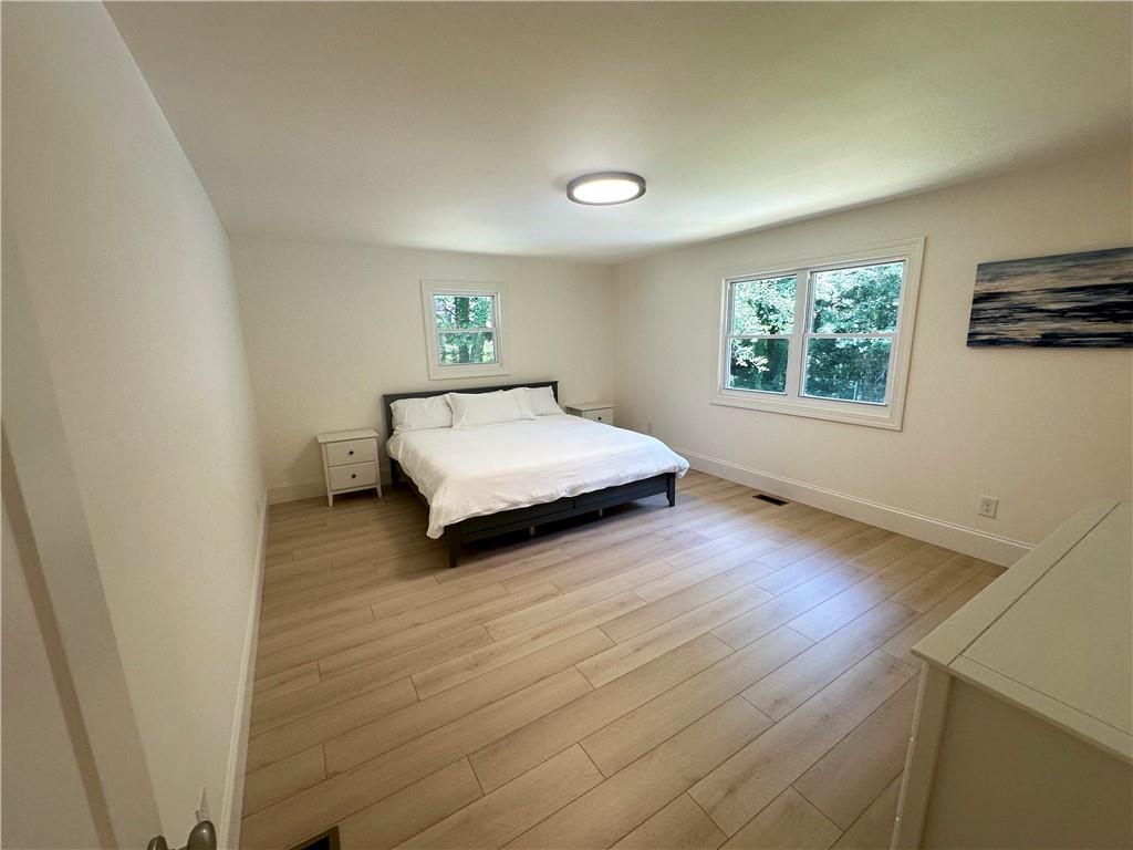 3405 Still Road Cumming, GA 30041 - Photo 11 of 28 a spacious bedroom with a bed and wooden floor