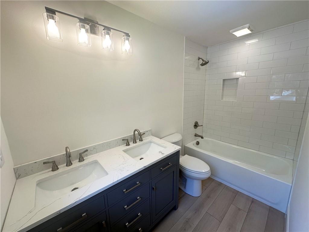 3405 Still Road Cumming, GA 30041 - Photo 12 of 28 a bathroom with a double vanity sink toilet and shower