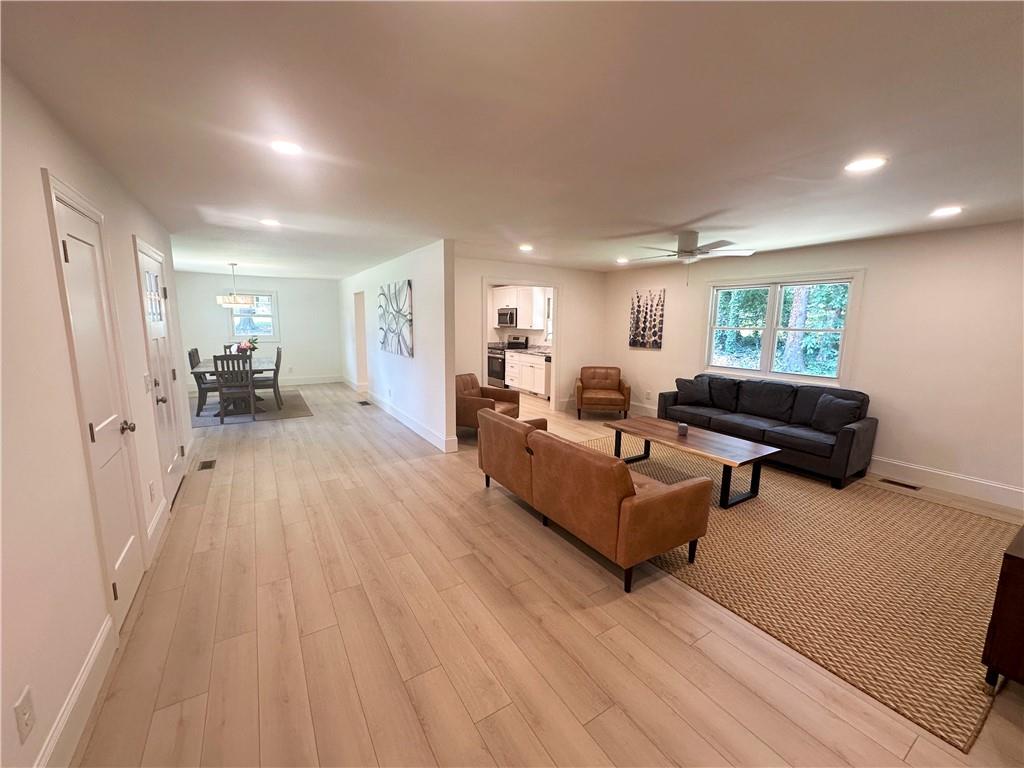 3405 Still Road Cumming, GA 30041 - Photo 2 of 28 a living room with furniture and a wooden floor