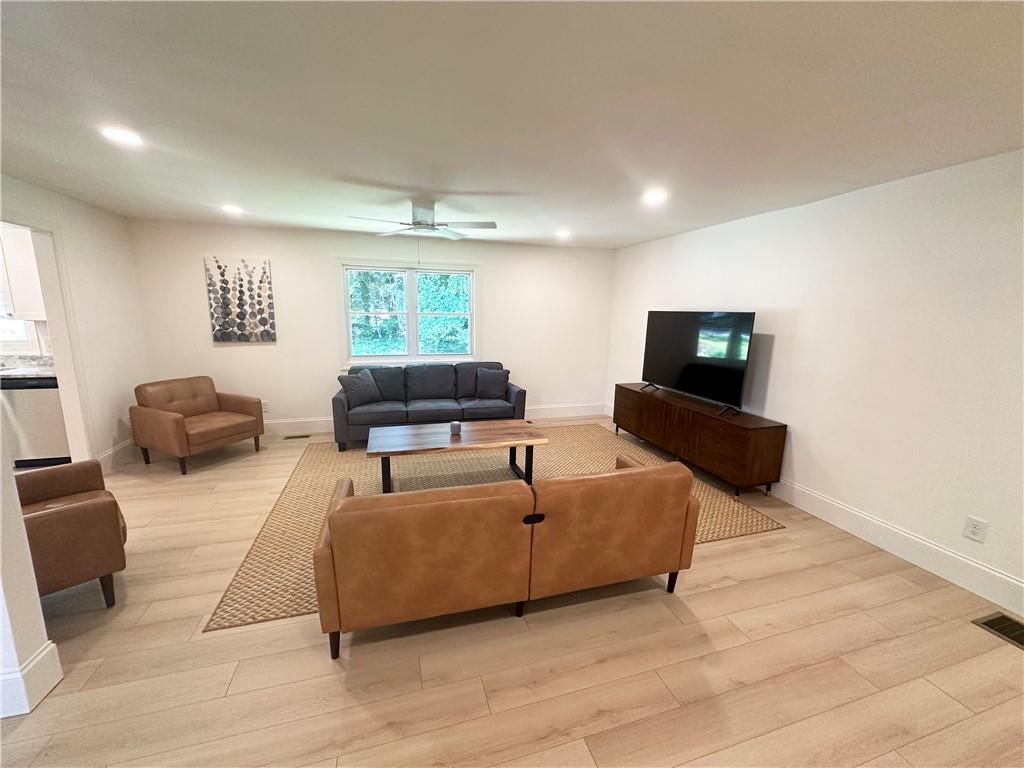 3405 Still Road Cumming, GA 30041 - Photo 4 of 28 a living room with furniture and a flat screen tv