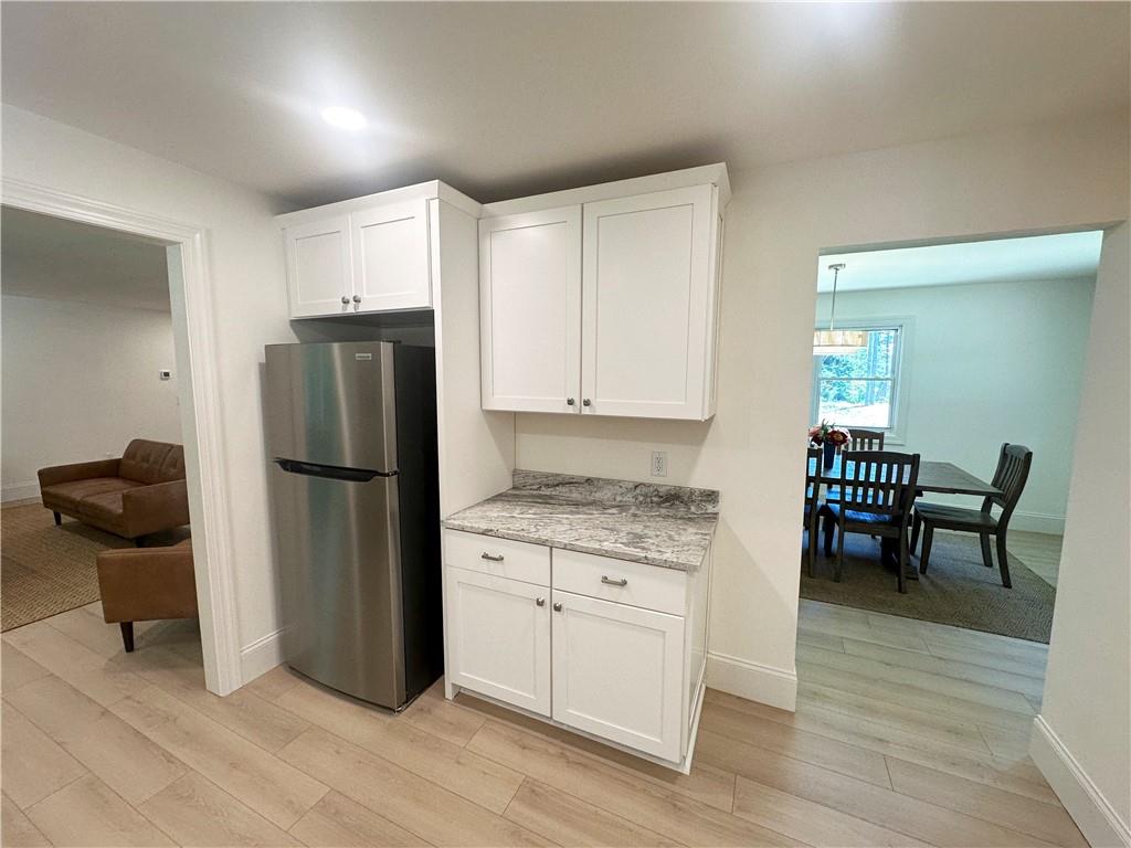 3405 Still Road Cumming, GA 30041 - Photo 8 of 28 a kitchen with a refrigerator and table chair