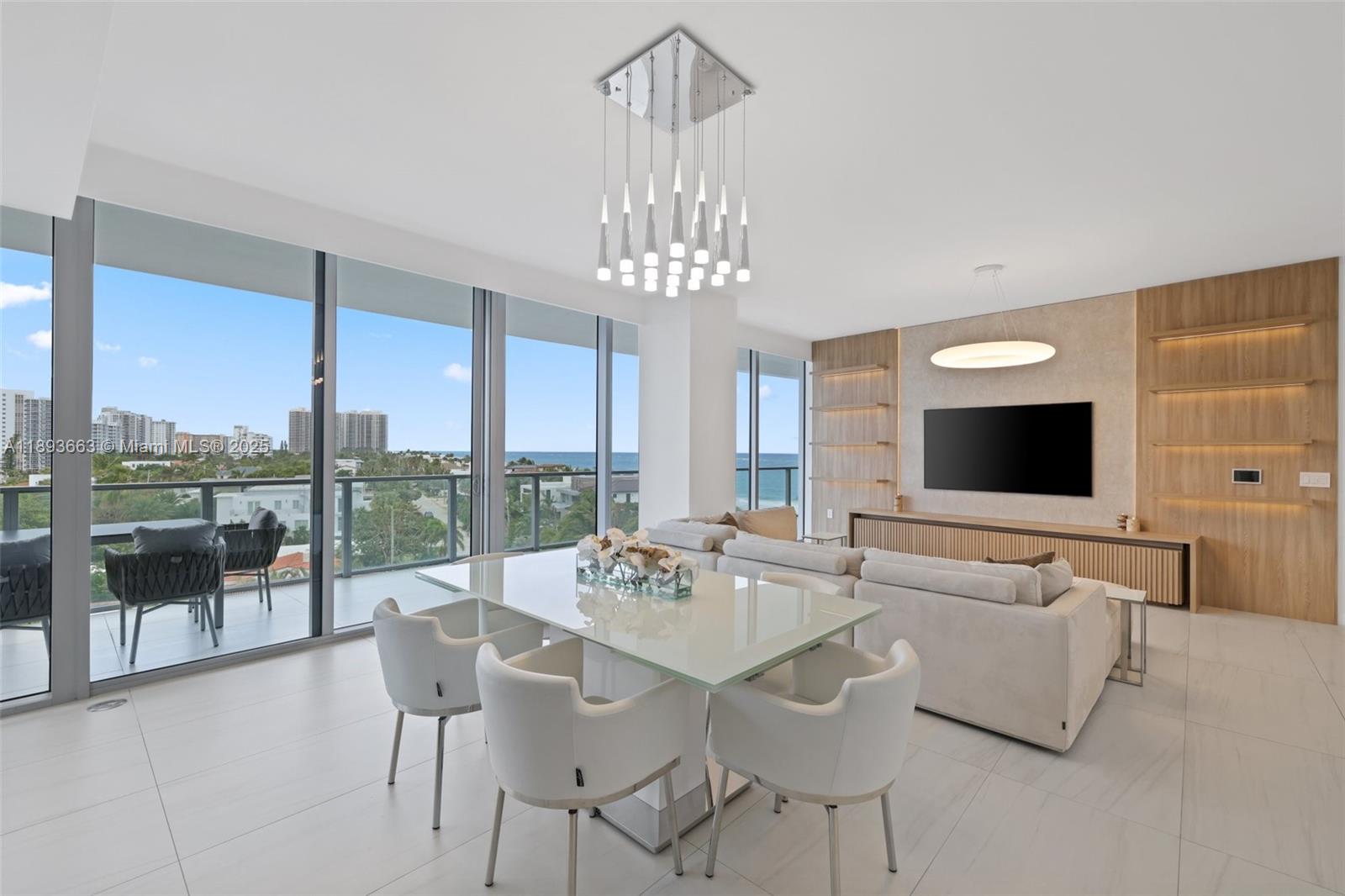 2200 North Ocean Boulevard, Unit N504 Fort Lauderdale, FL 33305 - Photo 12 of 43 a view of a dining room with furniture wooden floor and chandelier