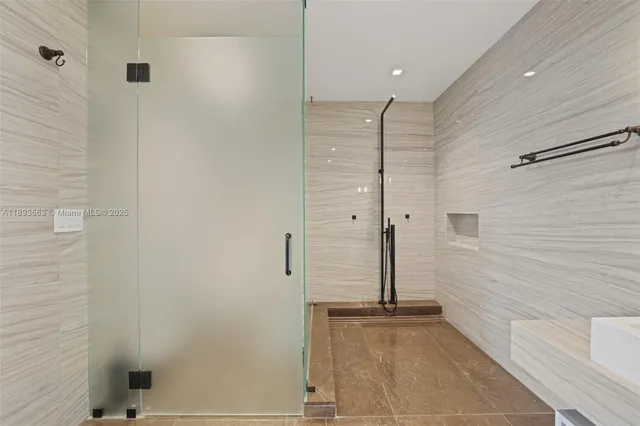 a bathroom with a shower and a sink