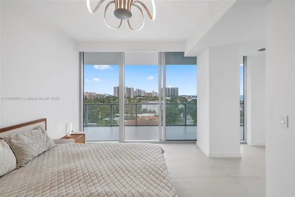 a bedroom with furniture and a large window