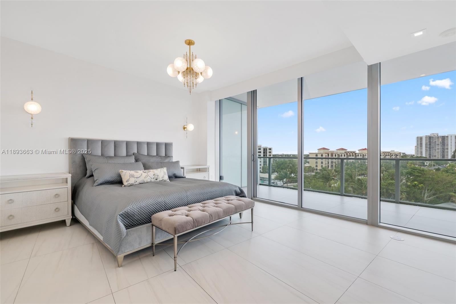 2200 North Ocean Boulevard, Unit N504 Fort Lauderdale, FL 33305 - Photo 2 of 43 a bedroom with a large bed and a chandelier